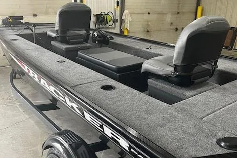 Slide: The Image of 2025 Tracker Panfish 17 boat with dual seats in a garage setting. - 2