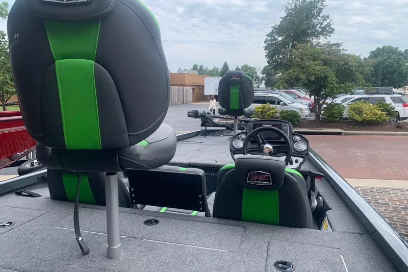 Slide: The Image of 2025 Ranger RT188 boat interior with green and black seats, parked outdoors. - 9