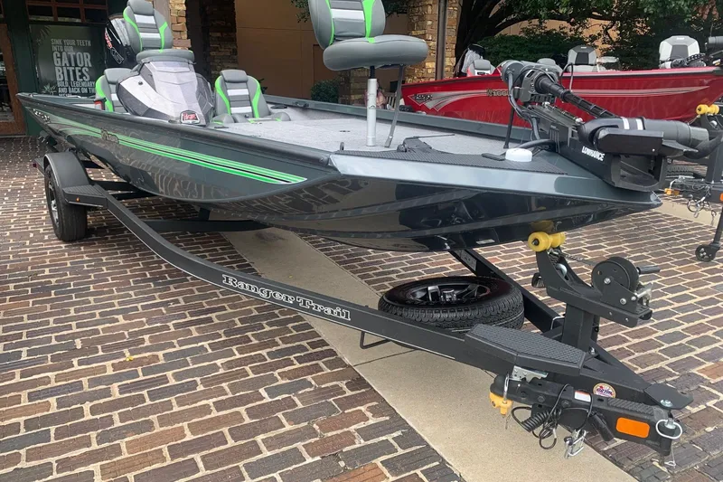 Slide: The Image of 2025 Ranger RT188 fishing boat on trailer, featuring sleek design and green accents. - 2
