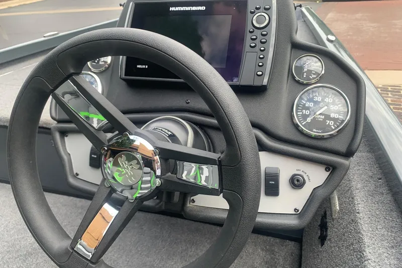 Slide: The Image of 2025 Ranger RT188 boat dashboard with steering wheel, gauges, and Humminbird Helix 8 display. - 7