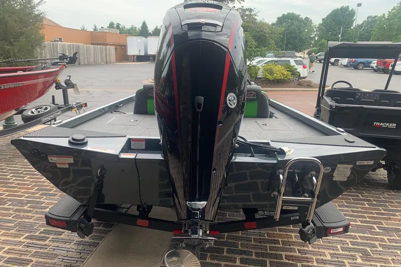 Slide: The Image of 2025 Ranger RT188 boat with powerful outboard motor, parked on a brick driveway. - 1