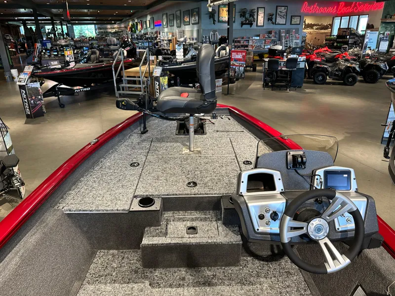 Slide: The Image of 2025 Tracker Pro Team 175 boat interior in showroom, featuring steering wheel and seating. - 4