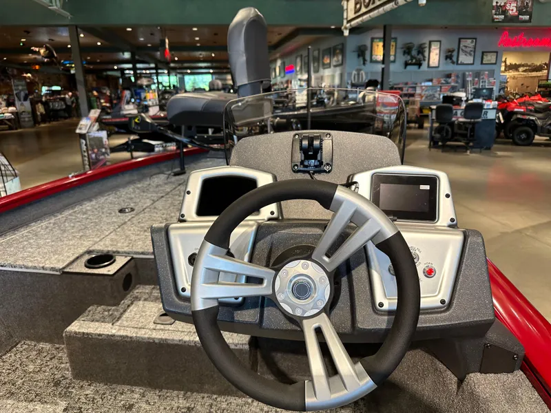 Slide: The Image of 2025 Tracker Pro Team 175 boat dashboard with steering wheel and dual displays. - 5