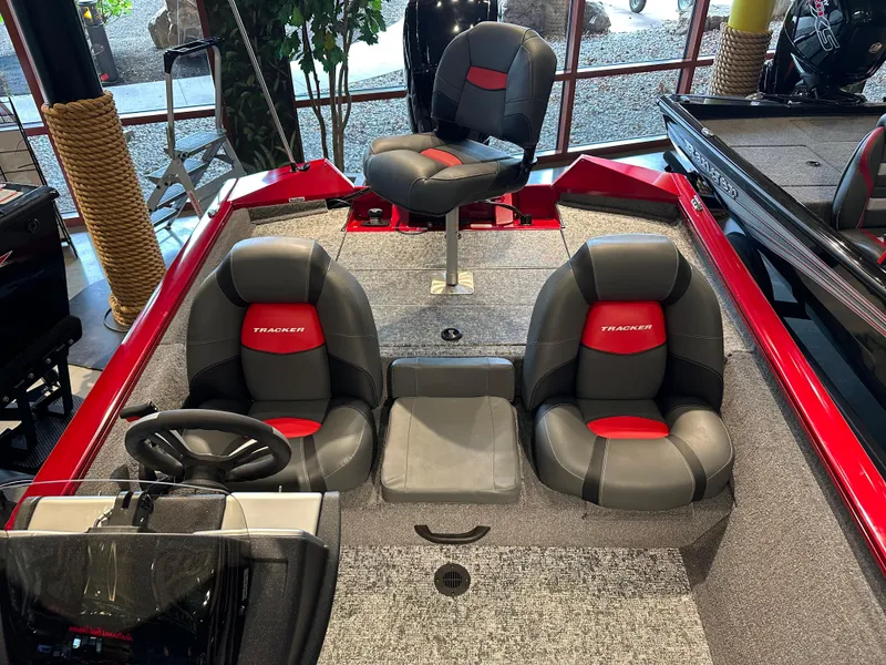 Slide: The Image of 2025 Tracker Pro Team 175 boat interior with three seats and steering wheel. - 6