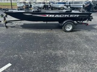 The Image of 2025 Tracker Panfish 17 boat on trailer, black exterior, parked outdoors. - 0