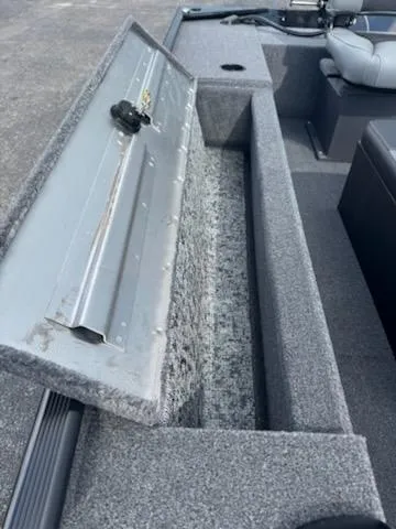 Slide: The Image of 2025 Tracker Panfish 17 boat interior with open storage compartment. - 8