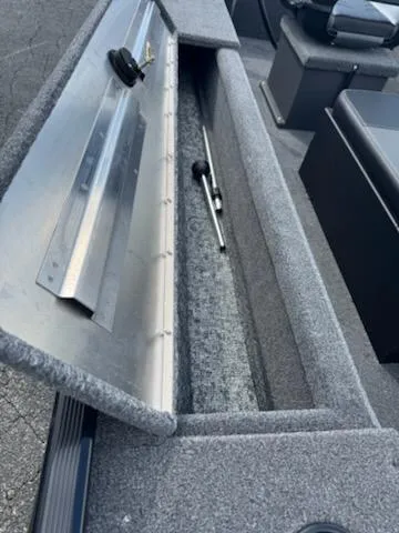 Slide: The Image of 2025 Tracker Panfish 17 boat storage compartment with open lid, showcasing interior space. - 9