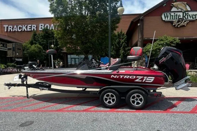 The Image of 2025 Nitro Z19 Pro boat displayed outside dealership, with trade-in offer sign. - 0