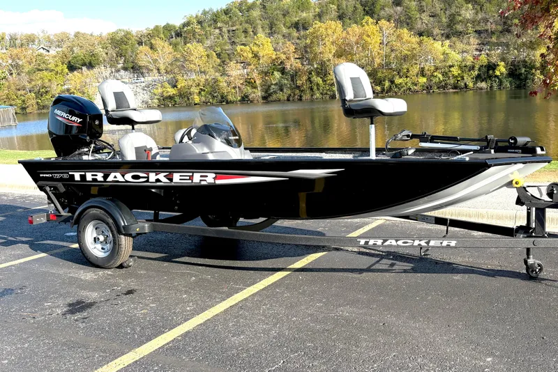 Slide: The Image of 2025 Tracker Pro 170 boat on trailer by a scenic lake. - 77