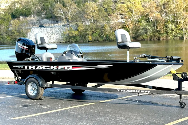 Slide: The Image of 2025 Tracker Pro 170 boat on trailer by a scenic lake. - 79