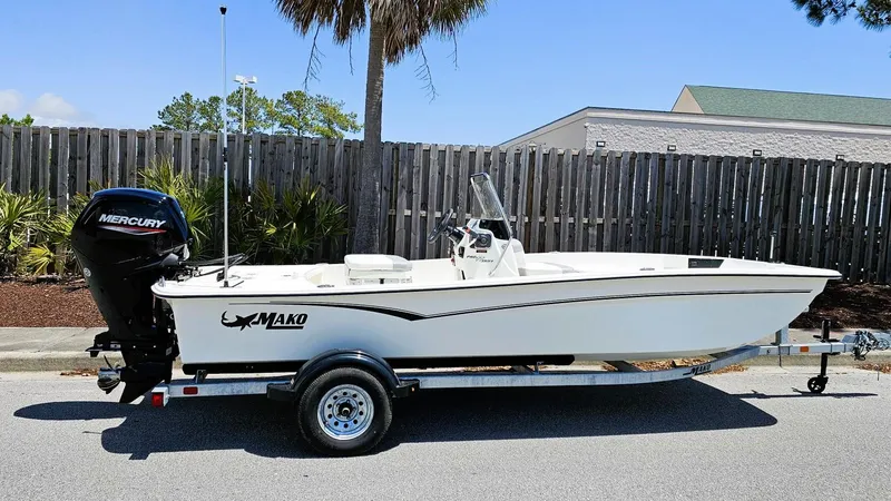 Slide: The Image of 2025 Mako Pro Skiff 17 CC boat on trailer, parked outdoors. - 0