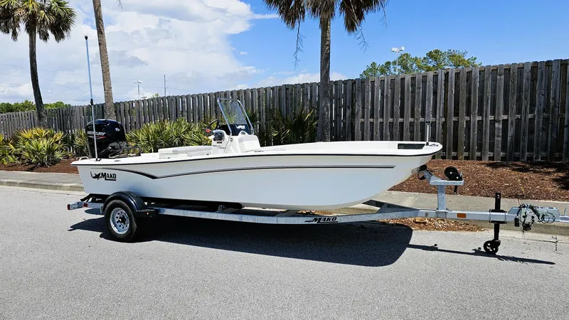 Slide: The Image of 2025 Mako Pro Skiff 17 CC boat on trailer, parked outdoors. - 1