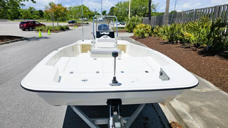 Slide: The Image of 2025 Mako Pro Skiff 17 CC boat on trailer in parking lot. - 11