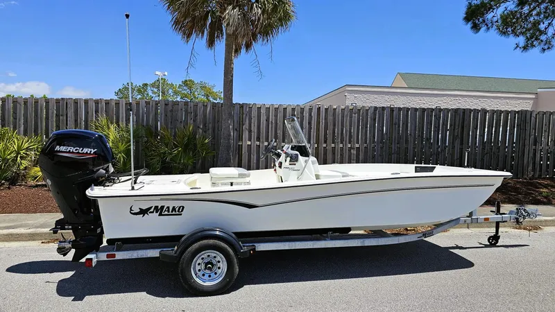Slide: The Image of 2025 Mako Pro Skiff 17 CC boat on trailer, parked outdoors. - 2