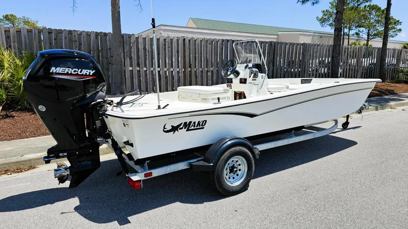 Slide: The Image of 2025 Mako Pro Skiff 17 CC boat on trailer with Mercury outboard motor. - 3