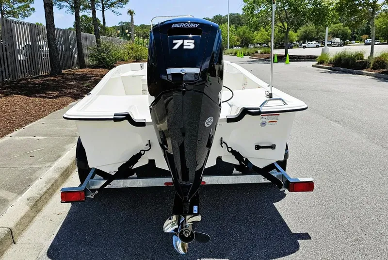 Slide: The Image of 2025 Mako Pro Skiff 17 CC with Mercury 75 engine, parked on a trailer. - 5