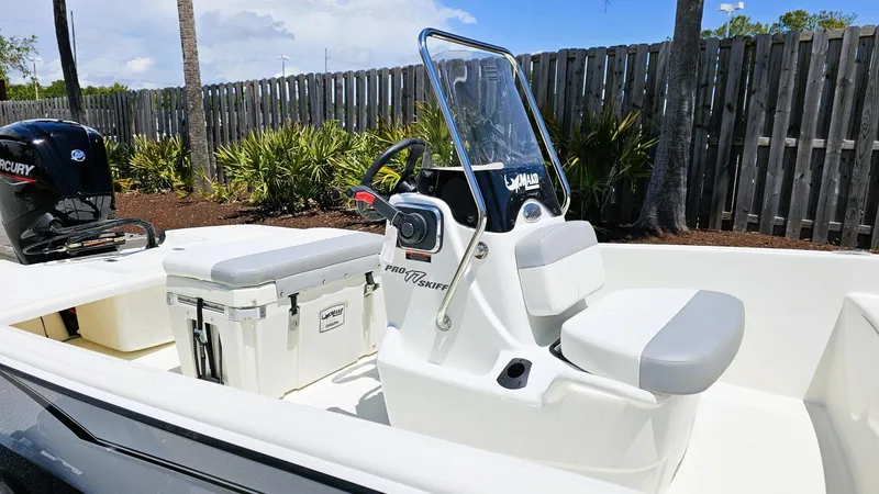 Slide: The Image of 2025 Mako Pro Skiff 17 CC boat with console and seating, outdoors. - 8