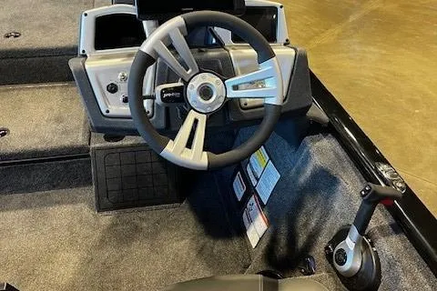 Slide: The Image of Steering console of 2025 Tracker Savage 215 boat with modern controls and sleek design. - 6