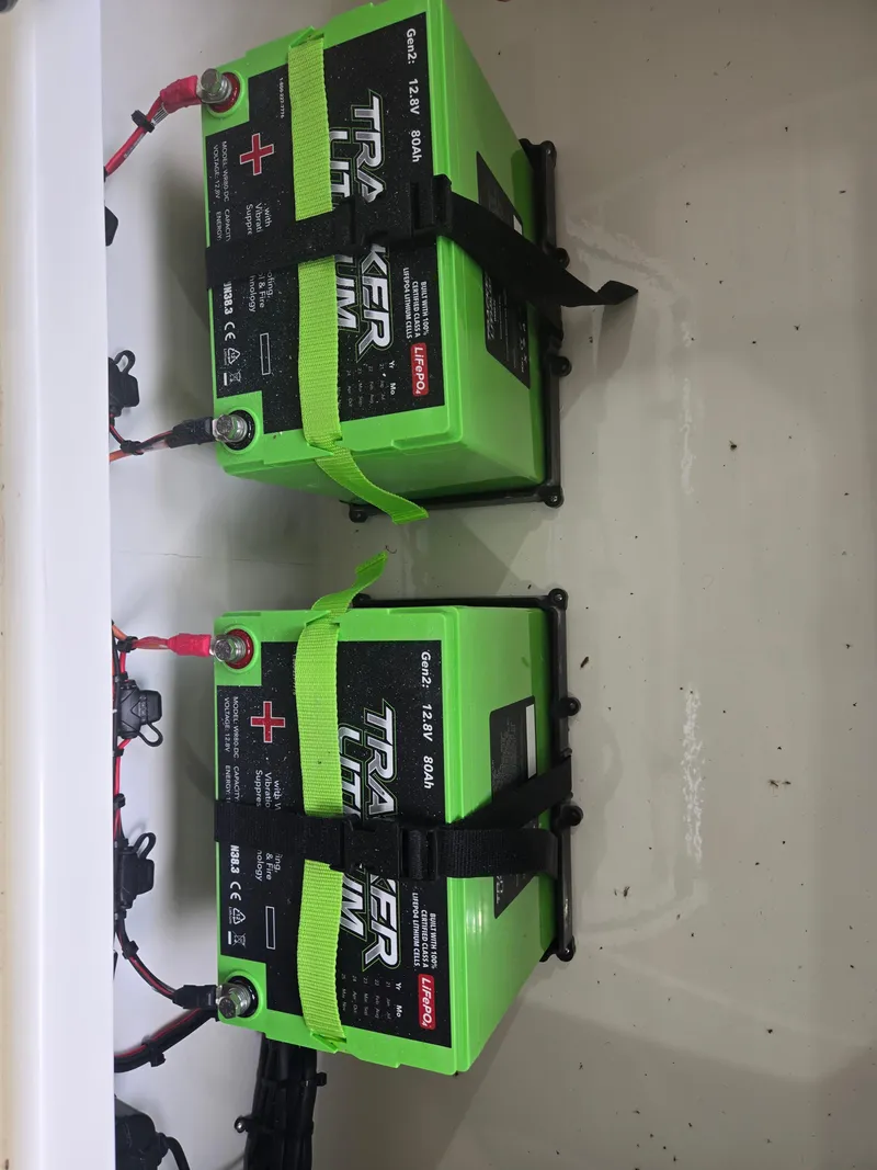 Slide: The Image of Two Tracker lithium batteries in a Mako 18 Pro Skiff Patriot Edition, 2025 model. - 3