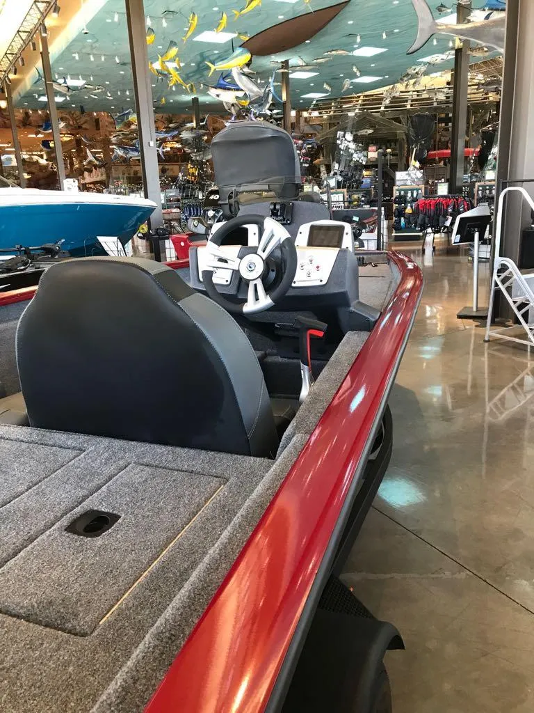 Slide: The Image of 2025 Tracker Pro Team 175 boat with red exterior, displayed indoors. - 5