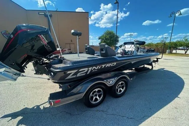 Slide: The Image of 2025 Nitro Z21 XL boat parked outside a service center. - 2