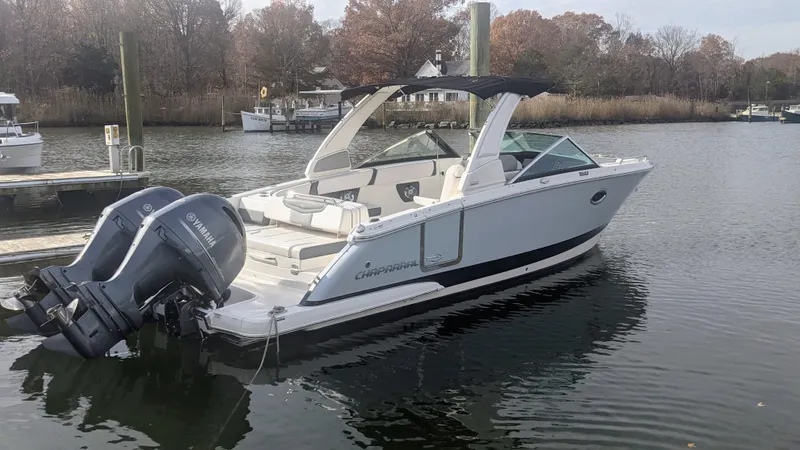The Image of 2020 Chaparral 280 OSX boat docked on calm water with Yamaha outboard engines. - 0