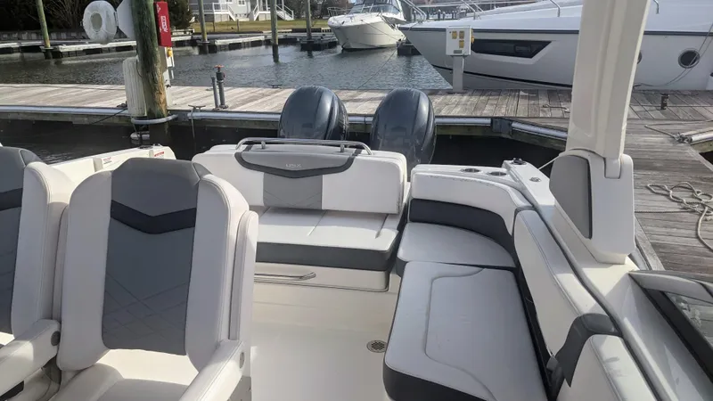 Slide: The Image of 2020 Chaparral 280 OSX boat interior with seating, docked at marina. - 11