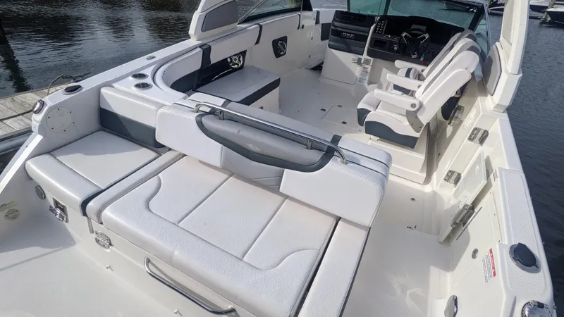 Slide: The Image of 2020 Chaparral 280 OSX boat interior with white seating and modern dashboard. - 13