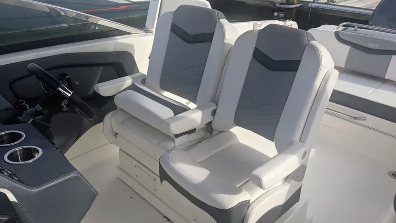 Slide: The Image of 2020 Chaparral 280 OSX boat interior with dual gray and white captain seats. - 14
