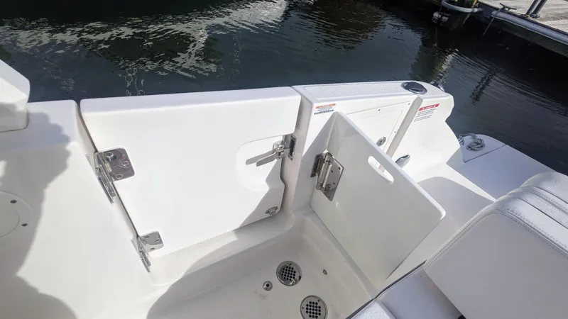 Slide: The Image of 2020 Chaparral 280 OSX boat deck with open hatch, near water. - 16