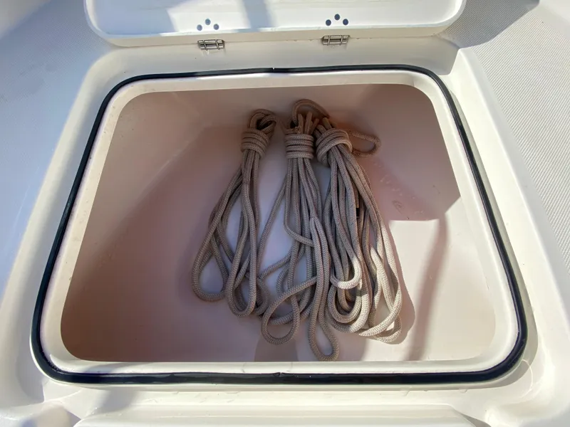 Slide: The Image of Storage compartment with ropes on a 2011 Pursuit C 200 Center Console boat. - 10