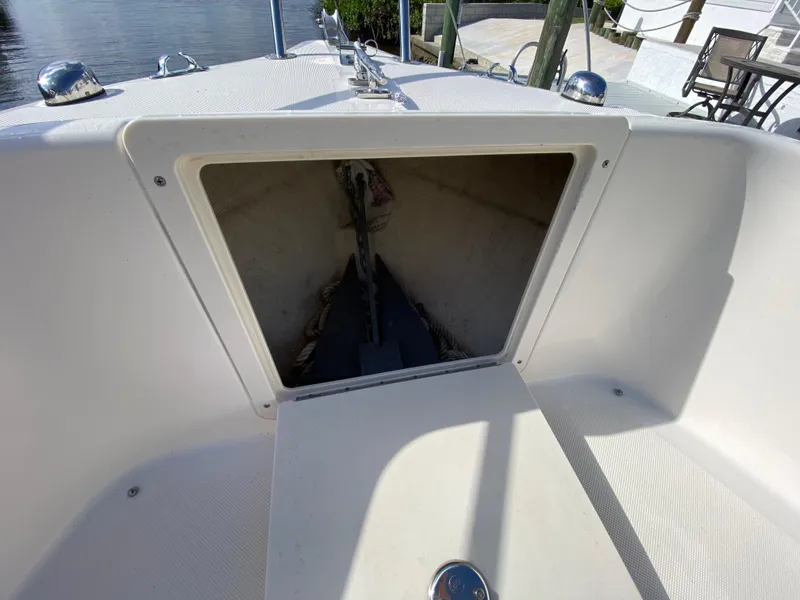 Slide: The Image of 2011 Pursuit C 200 Center Console boat anchor storage compartment, open and empty. - 11