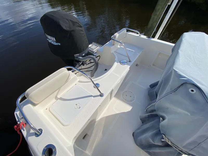 Slide: The Image of 2011 Pursuit C 200 Center Console boat with Yamaha engine, docked on calm water. - 13