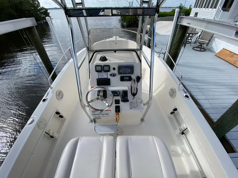 Slide: The Image of 2011 Pursuit C 200 Center Console boat with steering wheel and navigation controls. - 15
