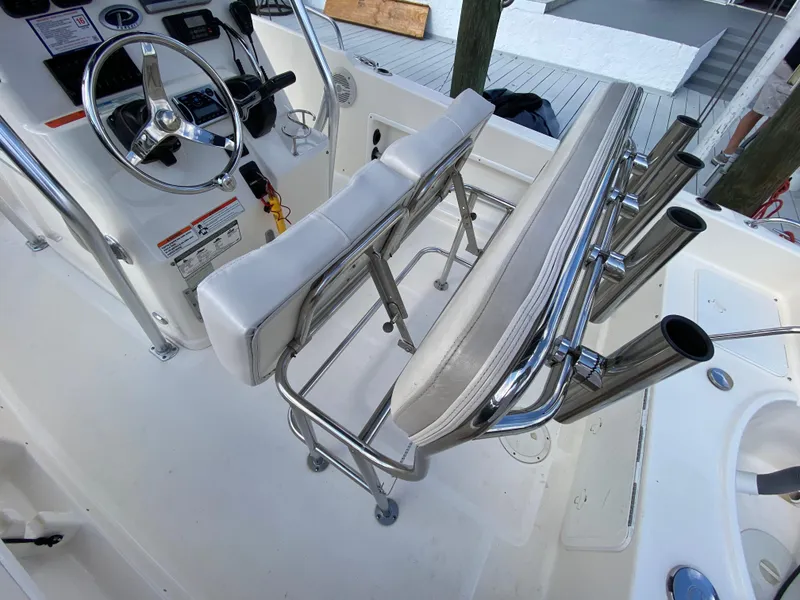 Slide: The Image of 2011 Pursuit C 200 Center Console boat interior with steering wheel and rod holders. - 16