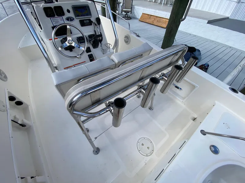 Slide: The Image of 2011 Pursuit C 200 Center Console boat interior with steering wheel and rod holders. - 17