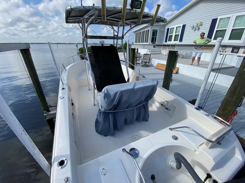 Slide: The Image of 2011 Pursuit C 200 Center Console boat docked by a waterfront house. - 19