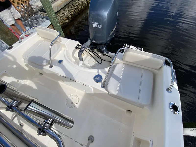 Slide: The Image of 2011 Pursuit C 200 Center Console boat with Yamaha 150 engine, docked by water. - 22