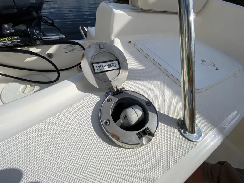 Slide: The Image of 2011 Pursuit C 200 Center Console boat with open freshwater compartment. - 24