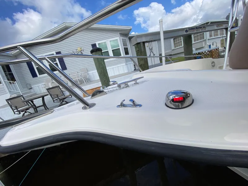 Slide: The Image of 2011 Pursuit C 200 Center Console boat docked near waterfront homes. - 25