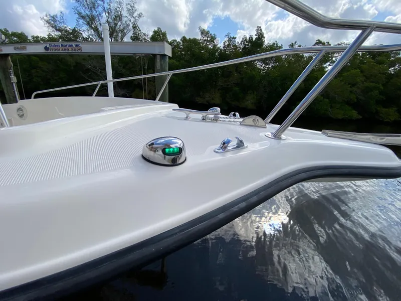 Slide: The Image of 2011 Pursuit C 200 Center Console boat deck with railing and navigation light. - 26