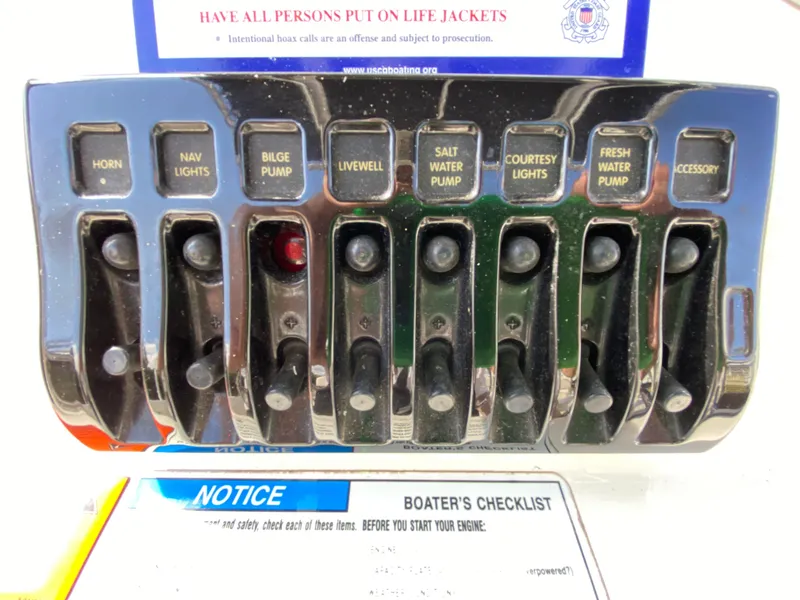 Slide: The Image of 2011 Pursuit C 200 Center Console control panel with various switches and boater's safety checklist. - 28