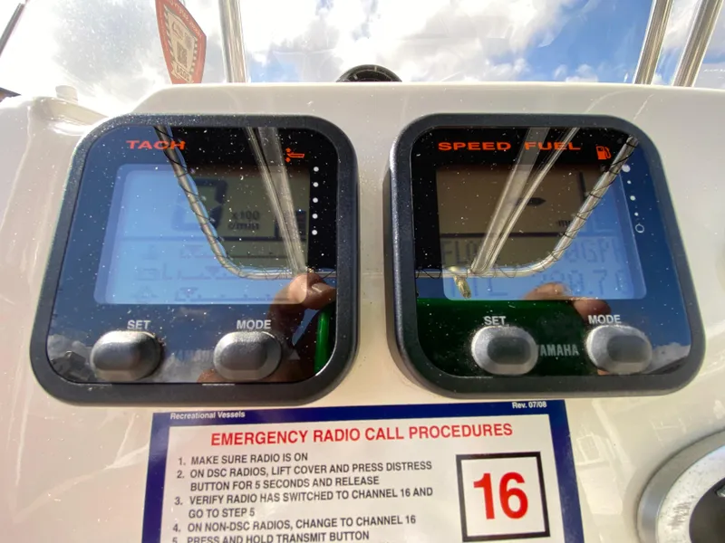 Slide: The Image of 2011 Pursuit C 200 Center Console dashboard with tachometer and speed fuel gauges. - 31