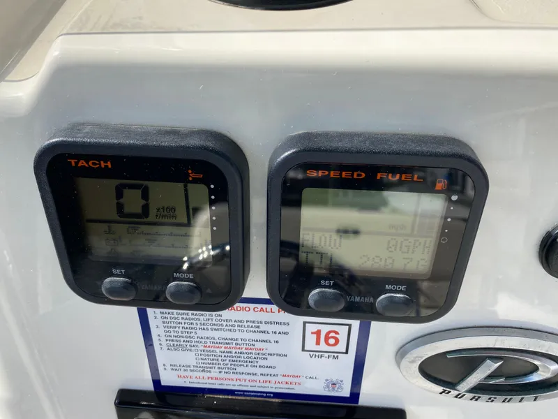 Slide: The Image of Digital gauges on a 2011 Pursuit C 200 Center Console boat dashboard. - 32