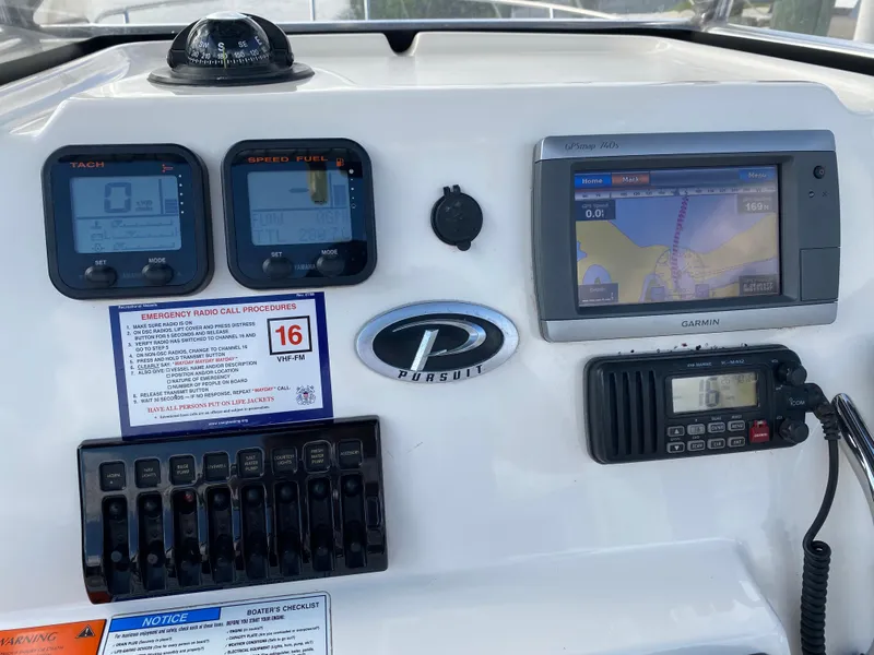 Slide: The Image of 2011 Pursuit C 200 Center Console dashboard with navigation and communication equipment. - 35