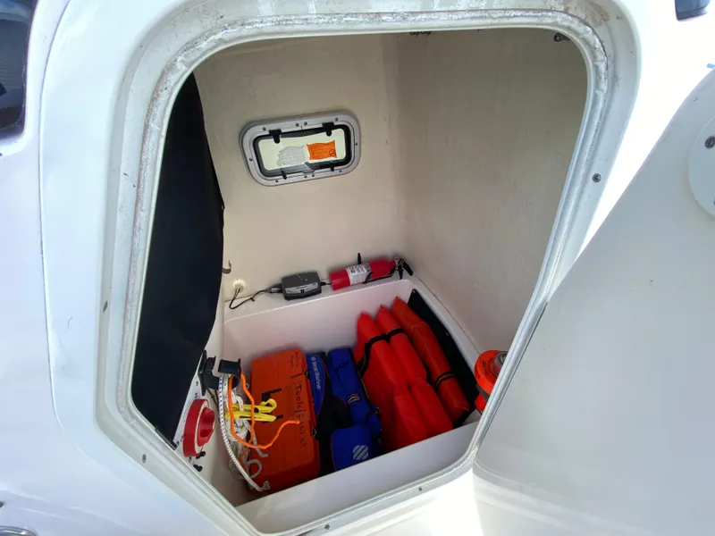 Slide: The Image of Storage compartment of 2011 Pursuit C 200 Center Console with safety gear and equipment. - 37