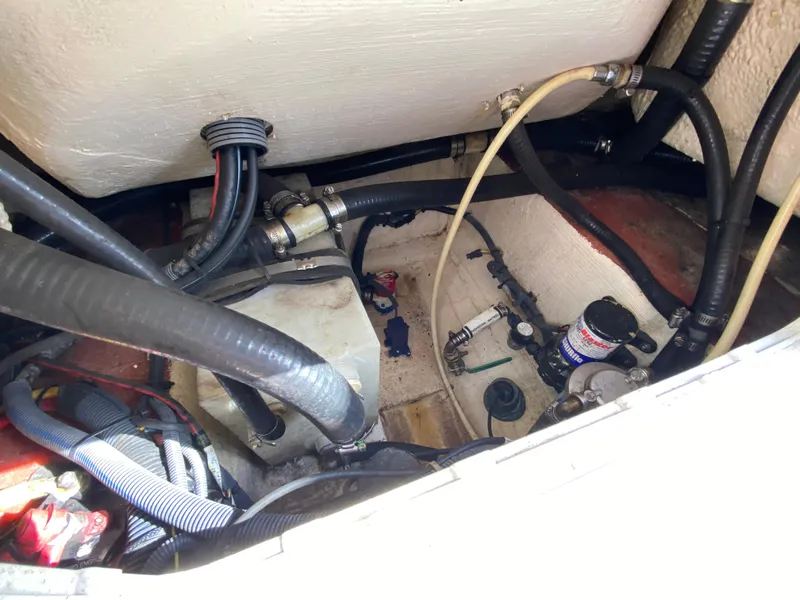 Slide: The Image of Engine compartment of a 2011 Pursuit C 200 Center Console boat, showing hoses and components. - 38