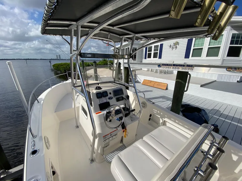 Slide: The Image of 2011 Pursuit C 200 Center Console boat docked by a waterfront home. - 4