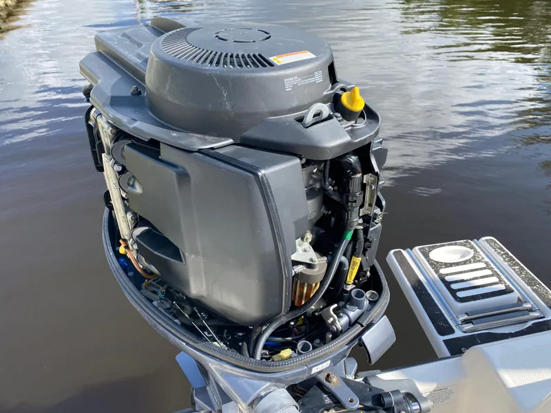 Slide: The Image of 2011 Pursuit C 200 Center Console boat engine by the water. - 40