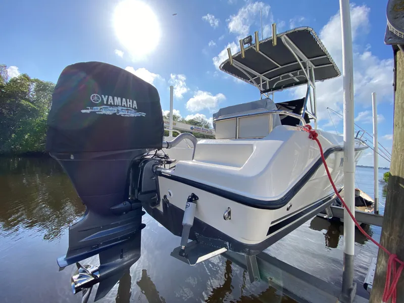 Slide: The Image of 2011 Pursuit C 200 Center Console boat with Yamaha engine, docked on a sunny day. - 5